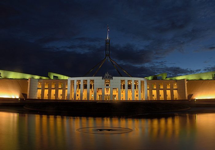 white concrete building near body of water